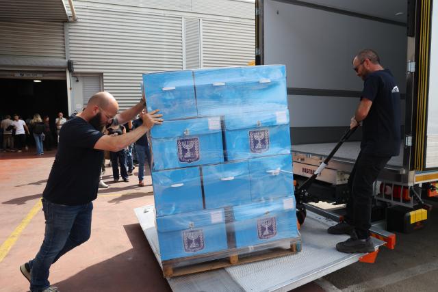 (261014) -- MODIIN, Oct. 14, 2026 (Xinhua) -- Workers transfer ballot boxes at a logistics center near the central Israeli city of Modiin, Oct. 14, 2026. The general elections for Israel's Knesset, the country's parliament, will be held on Oct. 27. All the preparations for the election are underway. (Photo by Gil Cohen Magen/Xinhua)