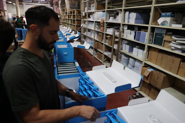 (261014) -- MODIIN, Oct. 14, 2026 (Xinhua) -- A worker prepares ballot boxes at a logistics center near the central Israeli city of Modiin, Oct. 14, 2026. The general elections for Israel's Knesset, the country's parliament, will be held on Oct. 27. All the preparations for the election are underway. (Photo by Gil Cohen Magen/Xinhua)