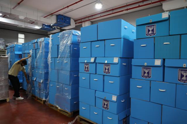 (261014) -- MODIIN, Oct. 14, 2026 (Xinhua) -- A worker arranges ballot boxes at a logistics center near the central Israeli city of Modiin, Oct. 14, 2026. The general elections for Israel's Knesset, the country's parliament, will be held on Oct. 27. All the preparations for the election are underway. (Photo by Gil Cohen Magen/Xinhua)