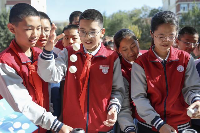 (261014) -- URUMQI, Oct. 14, 2026 (Xinhua) -- Students attend a science and technology festival at a middle school in Urumqi, northwest China's Xinjiang Uygur Autonomous Region, Oct. 14, 2026. (Xinhua/Wang Fei)