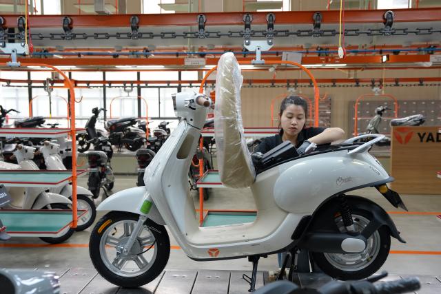 (261014) -- HANOI, Oct. 14, 2026 (Xinhua) -- A worker is busy at the manufacturing plant of Yadea in Bac Ninh province, Vietnam, July 7, 2026.
  Chinese electric motorcycle brands are becoming an increasingly common sight on the streets of Vietnam's major cities, as the country accelerates its shift toward greener urban transport.
  More Vietnamese residents have turned to electric motorcycles, with Chinese brands emerging as popular choices thanks to their competitive prices, diverse models and growing presence in the Vietnamese market. (Xinhua/Liu Ying)