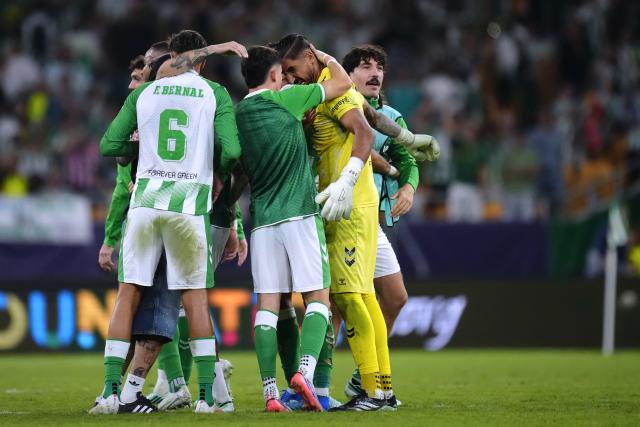(261015) -- SEVILLE, Oct. 15, 2026 (Xinhua) -- Players of Betis celebrate for goal during the UEFA Champions League match between Real Betis and Porto at La Cartuja Stadium in Seville, Spain, Oct. 14, 2026. (Str/Xinhua)