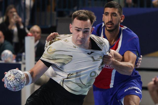 (261015) -- CELJE, Oct. 15, 2026 (Xinhua) -- Uros Milicevic (L) of RK Celje Pivovarna Lasko vies with Yahia Khaled Fathy Omar of Paris Saint-Germain during the European Handball Federation (EHF) Champions League match between RK Celje Pivovarna Lasko and Paris Saint-Germain at Zlatorog Sports Hall in Celje, Slovenia, Oct.14, 2026. (Photo by Zeljko Stevanic/Xinhua)