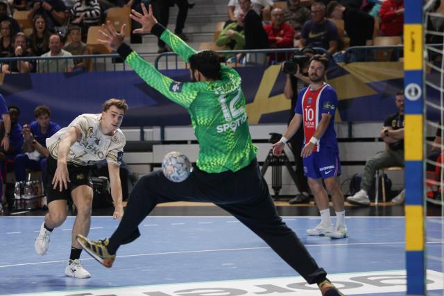 (261015) -- CELJE, Oct. 15, 2026 (Xinhua) -- Zan Kovac (L) of RK Celje Pivovarna Lasko scores during the European Handball Federation (EHF) Champions League match between RK Celje Pivovarna Lasko and Paris Saint-Germain at Zlatorog Sports Hall in Celje, Slovenia, Oct.14, 2026. (Photo by Zeljko Stevanic/Xinhua)