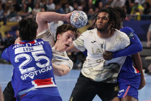 (261015) -- CELJE, Oct. 15, 2026 (Xinhua) -- Lun Kljucanin (2nd L) of RK Celje Pivovarna Lasko vies with Simen Ulstad Lyse (1st L) of Paris Saint-Germain during the European Handball Federation (EHF) Champions League match between RK Celje Pivovarna Lasko and Paris Saint-Germain at Zlatorog Sports Hall in Celje, Slovenia, Oct.14, 2026. (Photo by Zeljko Stevanic/Xinhua)