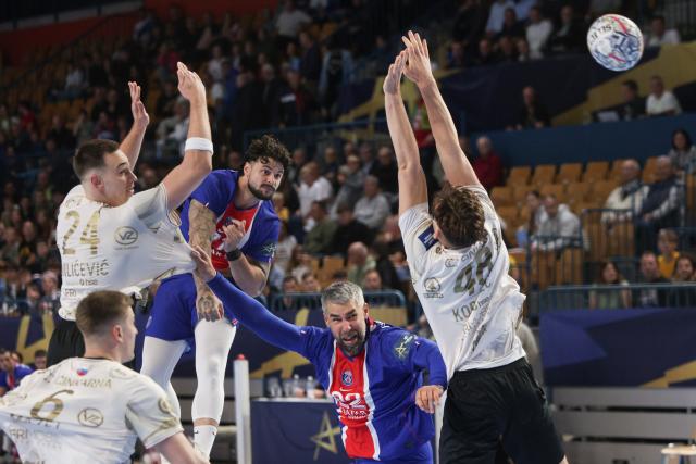(261015) -- CELJE, Oct. 15, 2026 (Xinhua) -- Elohim Prandi (top C) of Paris Saint-Germain shoots the ball during the European Handball Federation (EHF) Champions League match between RK Celje Pivovarna Lasko and Paris Saint-Germain at Zlatorog Sports Hall in Celje, Slovenia, Oct.14, 2026. (Photo by Zeljko Stevanic/Xinhua)