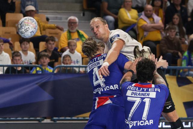 (261015) -- CELJE, Oct. 15, 2026 (Xinhua) -- Ziga Mlakar (top C) of RK Celje Pivovarna Lasko shoots the ball during the European Handball Federation (EHF) Champions League match between RK Celje Pivovarna Lasko and Paris Saint-Germain at Zlatorog Sports Hall in Celje, Slovenia, Oct.14, 2026. (Photo by Zeljko Stevanic/Xinhua)