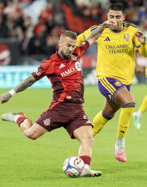 (261015) -- TORONTO, Oct. 15, 2026 (Xinhua) -- Niklas Dorsch (L) of Toronto FC shoots during the 2026 Major League Soccer (MLS) regular season match between Toronto FC and Orlando City SC at BMO Field in Toronto, Canada, Oct. 14, 2026. (Photo by Zou Zheng/Xinhua)