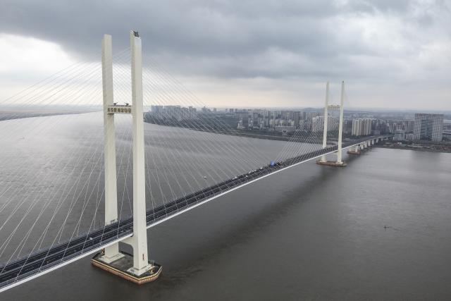 (261015) -- DANDONG, Oct. 15, 2026 (Xinhua) -- A drone photo taken on Oct. 15, 2026 shows a view of the new China-DPRK Yalu River bridge. The new China-DPRK Yalu River bridge officially opened to traffic on Thursday, with both sides jointly holding an opening ceremony on this cross-border artery. (Xinhua/Pan Yulong)
