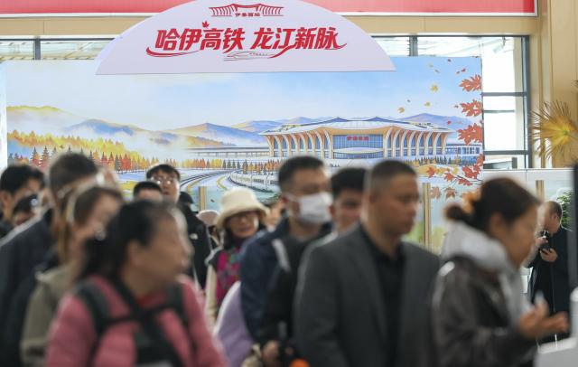 (261015) -- HARBIN, Oct. 15, 2026 (Xinhua) -- Passengers line up for check-in at the waiting hall of Yichun West Railway Station in Yichun City, northeast China's Heilongjiang Province, Oct. 14, 2026.
  The Harbin-Yichun high-speed railway, China's northernmost high-speed railway running through a region of discontinuous permafrost in northeast China's Heilongjiang Province, officially entered service on Sept. 28. With a designed speed of 250 kilometers per hour, the 318-km line slashed travel time between Harbin and Yichun from about seven hours to just two hours.
   The efficient and convenient rail service is expected to facilitate the free flow of talents, passengers, materials and technologies, boosting coordinated regional development in Heilongjiang and forming a key corridor for the region's high-quality development. (Xinhua/Wang Song)