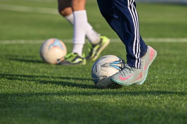 (261015) -- URUMQI, Oct. 15, 2026 (Xinhua) -- Players train at Xinjiang Special Education Vocational Secondary School in Changji Hui Autonomous Prefecture, northwest China's Xinjiang Uygur Autonomous Region, Oct. 12, 2026. Xinjiang's first blind football team is known as the 'Wei Wei Wei' team. It takes its name from the call players shout to locate teammates and avoid collisions. This call is the communication code of this special sport.
In blind football, players wear light-blocking blindfolds throughout the match. They track the ball by the bell inside it and keep calling 'wei, wei, wei' to gauge teammates' positions, enabling them to dribble, pass and shoot without sight. In training, they run, collide, feel the boundary boards, and build muscle memory through countless falls and getting back up. For visually impaired teenagers who rarely dare to sprint at full speed in daily life, this enclosed pitch is a place where they can run freely.
'We cannot see the world, but we strive to make the world see us.' In the darkness, guided by their calls and the sound of the ball, these young athletes break through barriers and shine brightly on the green pitch. (Xinhua/Ding Lei)