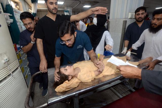 (261015) -- PESHAWAR, Oct. 15, 2026 (Xinhua) -- Medical staff treat an injured student at a hospital after the roof of a private school collapsed in Peshawar, Pakistan, on Oct. 15, 2026. At least 28 people, including 27 students and a female teacher, were killed after the roof of a private school collapsed in Peshawar, the capital of Pakistan's northwestern Khyber Pakhtunkhwa province, on Thursday, hospital officials said. (Xinhua)