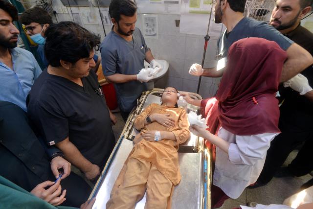 (261015) -- PESHAWAR, Oct. 15, 2026 (Xinhua) -- Medical staff treat an injured student at a hospital after the roof of a private school collapsed in Peshawar, Pakistan, on Oct. 15, 2026. At least 28 people, including 27 students and a female teacher, were killed after the roof of a private school collapsed in Peshawar, the capital of Pakistan's northwestern Khyber Pakhtunkhwa province, on Thursday, hospital officials said. (Xinhua)