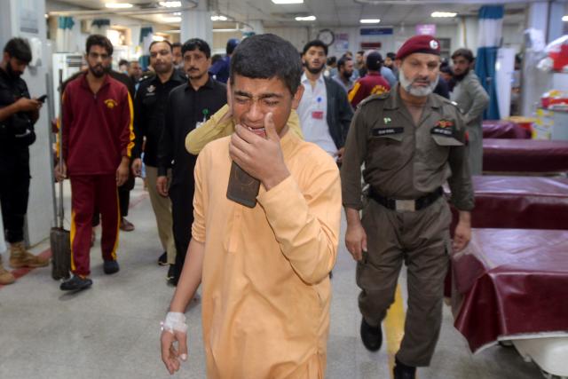(261015) -- PESHAWAR, Oct. 15, 2026 (Xinhua) -- A student weeps as he talks on the phone with his family at a hospital after the roof of a private school collapsed in Peshawar, Pakistan, on Oct. 15, 2026. At least 28 people, including 27 students and a female teacher, were killed after the roof of a private school collapsed in Peshawar, the capital of Pakistan's northwestern Khyber Pakhtunkhwa province, on Thursday, hospital officials said. (Xinhua)