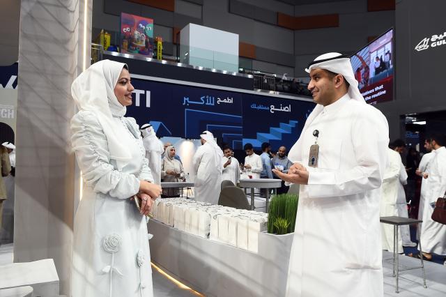 (261015) -- HAWALLI GOVERNORATE, Oct. 15, 2026 (Xinhua) -- People talk during the Watheefti career fair in Hawalli Governorate, Kuwait, Oct. 15, 2026. The Watheefti 2026 career fair opened in Kuwait's Hawalli Governorate on Thursday, bringing together more than 120 companies and organizations from various sectors. The three-day event, running through to Oct. 17, aims to connect jobseekers with potential employers, offer career guidance and training opportunities. (Photo by Asad/Xinhua)