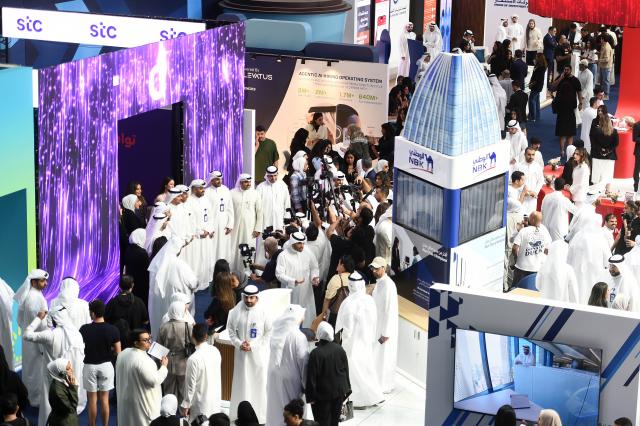 (261015) -- HAWALLI GOVERNORATE, Oct. 15, 2026 (Xinhua) -- People visit the Watheefti career fair in Hawalli Governorate, Kuwait, Oct. 15, 2026. The Watheefti 2026 career fair opened in Kuwait's Hawalli Governorate on Thursday, bringing together more than 120 companies and organizations from various sectors. The three-day event, running through to Oct. 17, aims to connect jobseekers with potential employers, offer career guidance and training opportunities. (Photo by Asad/Xinhua)