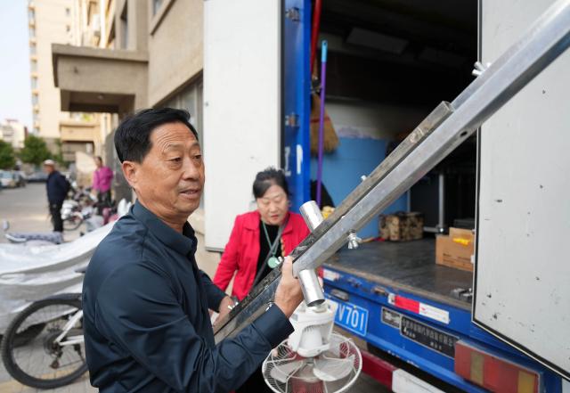 (261015) -- SHENYANG, Oct. 15, 2026 (Xinhua) -- Xu Zilin (front) arranges stage props for shadow puppetry performance in Lingyuan City, northeast China's Liaoning Province, Oct. 10, 2026.
  Lingyuan shadow puppetry, a national-level intangible cultural heritage in China, comes vividly alive amid dazzling light and shadow. Movements of the puppets embody the local folk traditions, which have been passed down through generations.
  Xu Zilin was born in 1964 to a family that has the Lingyuan shadow puppetry as its walk of life for ages. More than 40 years of professional experience made Xu a representative inheritor of the craft and an influential figure in the trade. Many of his vocal passages have been modeled for teaching.
  To better promote shadow plays, Xu founded a shadow puppetry troupe and brought quality productions to the grassroots level. Over the years, Xu and his troupe have performed more than 4,000 shows in Liaoning and neighboring provinces. (Xinhua/Li Gang)