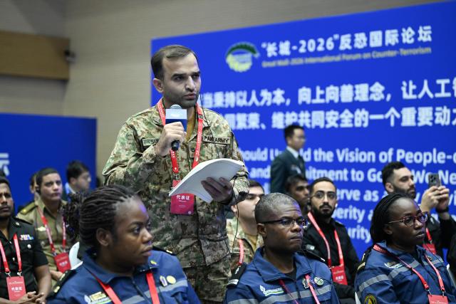 (261015) -- BEIJING, Oct. 15, 2026 (Xinhua) -- A participant talks during the Great Wall-2026 International Forum on Counter-Terrorism in Beijing, capital of China, Oct. 14, 2026. The Great Wall-2026 International Forum on Counter-Terrorism concluded here on Thursday. (Photo by Ze Fangningchen/Xinhua)