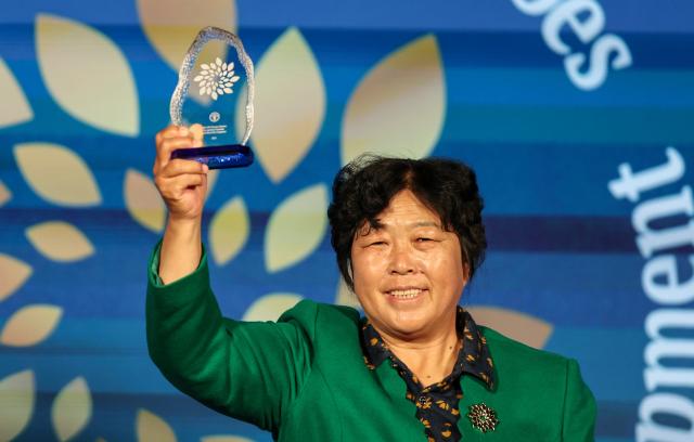 (261015) -- ROME, Oct. 15, 2026 (Xinhua) -- Yin Yuzhen attends a ceremony for Food and Agriculture Organization of the United Nations' (FAO) 100 Women Heroes in Agrifood Systems and Rural Development, in Rome, Italy, Oct. 15, 2026. Chinese sand-control pioneer Yin Yuzhen has been named among the FAO's 100 Women Heroes in Agrifood Systems and Rural Development, a global recognition initiative launched by the FAO.
  Yin has spent more than four decades combating desertification in the Maowusu Sandy Land in north China's Inner Mongolia Autonomous Region. After decades of persistent tree planting, she and her family have transformed stretches of the once-barren landscape into a green expanse, overcoming harsh conditions and shifting sands.
  Her story also forged an enduring friendship with retired U.S. teacher Ronald Sakolsky, who raised 5,000 U.S. dollars decades ago to support her afforestation work. (Xinhua/Wang Kaiyan)