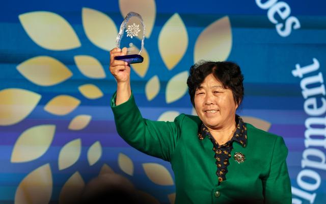 (261015) -- ROME, Oct. 15, 2026 (Xinhua) -- Yin Yuzhen attends a ceremony for Food and Agriculture Organization of the United Nations' (FAO) 100 Women Heroes in Agrifood Systems and Rural Development, in Rome, Italy, Oct. 15, 2026. Chinese sand-control pioneer Yin Yuzhen has been named among the FAO's 100 Women Heroes in Agrifood Systems and Rural Development, a global recognition initiative launched by the FAO.
  Yin has spent more than four decades combating desertification in the Maowusu Sandy Land in north China's Inner Mongolia Autonomous Region. After decades of persistent tree planting, she and her family have transformed stretches of the once-barren landscape into a green expanse, overcoming harsh conditions and shifting sands.
  Her story also forged an enduring friendship with retired U.S. teacher Ronald Sakolsky, who raised 5,000 U.S. dollars decades ago to support her afforestation work. (Xinhua/Wang Kaiyan)