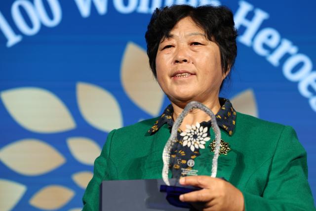 (261015) -- ROME, Oct. 15, 2026 (Xinhua) -- Yin Yuzhen attends a ceremony for Food and Agriculture Organization of the United Nations' (FAO) 100 Women Heroes in Agrifood Systems and Rural Development, in Rome, Italy, Oct. 15, 2026. Chinese sand-control pioneer Yin Yuzhen has been named among the FAO's 100 Women Heroes in Agrifood Systems and Rural Development, a global recognition initiative launched by the FAO.
  Yin has spent more than four decades combating desertification in the Maowusu Sandy Land in north China's Inner Mongolia Autonomous Region. After decades of persistent tree planting, she and her family have transformed stretches of the once-barren landscape into a green expanse, overcoming harsh conditions and shifting sands.
  Her story also forged an enduring friendship with retired U.S. teacher Ronald Sakolsky, who raised 5,000 U.S. dollars decades ago to support her afforestation work. (Xinhua/Li Jing)