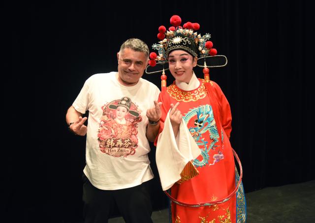 (261015) -- VIENNA, Oct. 15, 2026 (Xinhua) -- Chinese Huangmei Opera artist Han Zaifen (R) poses for photos with one of the local audience after a Huangmei opera performance in Vienna, Austria, Oct. 15, 2026. (Xinhua/He Canling)