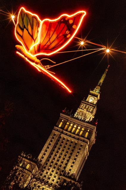 (261015) -- WARSAW, Oct. 15, 2026 (Xinhua) -- This photo taken on Oct. 15, 2026 shows an illuminated butterfly installation in a light garden in Swietokrzyski Park, with the Palace of Culture and Science in the background, in Warsaw, Poland. The year-round light garden opened on Thursday, featuring illuminated plant and butterfly installations and interactive projections that respond to visitors' movements. (Photo by Jaap Arriens/Xinhua)