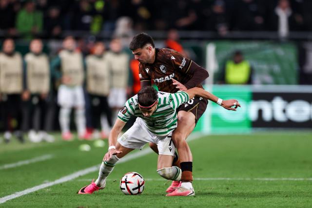(261016) -- BUDAPEST, Oct. 16, 2026 (Xinhua) -- Veljko Birmancevic (bottom) of Ferencvaros vies with Stefan Pirgic of Viktoria Plzen during the UEFA Europa League 2026/27 League Phase match between Ferencvaros and Viktoria Plzen in Budapest, Hungary, Oct. 15, 2026. (Xinhua/Hu Zhixuan)
