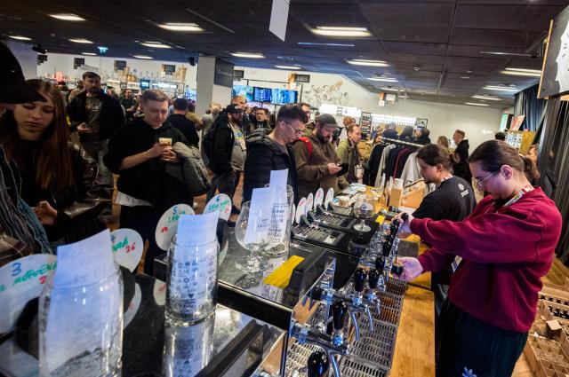 (261016) -- WARSAW, Oct. 16, 2026 (Xinhua) -- Staff members serve beer to visitors at the 22nd Warsaw Beer Festival in Warsaw, Poland, Oct. 15, 2026. The festival runs from Oct. 15 to 17 at Legia Warsaw Stadium, featuring beer tastings, food trucks, workshops and live music. Launched in 2014, the festival is held every spring and autumn. (Photo by Jaap Arriens/Xinhua)