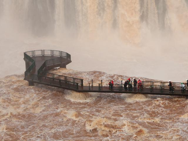(261016) -- IGUAZU, Oct. 16, 2026 (Xinhua) -- This photo taken on Oct. 14, 2026 shows staff members working on a walkway at Iguazu Falls in the state of Parana, Brazil. A walkway at Iguazu Falls, a major tourist attraction on the Brazil-Argentina border, was closed as a precaution Sunday after heavy rain caused exceptionally high water levels in the Iguazu River, local authorities said.
   The concessionaire responsible for tourism operations, Urbia+Cataratas, and the Chico Mendes Institute for Biodiversity Conservation, which manages the park, are continuing to monitor river conditions. (Urbia+Cataratas/Handout via Xinhua)