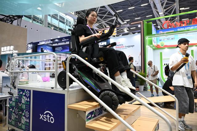 (261016) -- GUANGZHOU, Oct. 16, 2026 (Xinhua) -- A staff member controls a smart wheelchair to go down the stairs during the Canton Fair in Guangzhou, south China's Guangdong Province, Oct. 15, 2026. The 140th edition of the China Import and Export Fair, also known as the Canton Fair, opened to visitors in Guangzhou, capital of south China's Guangdong Province on Thursday, with more than 30,000 exhibiting companies and about 340,000 overseas buyers expected to attend.
  Serving as a barometer and wind vane of China's foreign trade, this year's fair, marking its 70th anniversary, features innovation, intelligence, greater specialization and higher quality.
  The Canton Fair is one of the world's few one-stop trade platforms offering a complete range of products with convenience and efficiency, while bringing together the latest products and technologies. (Xinhua/Deng Hua)