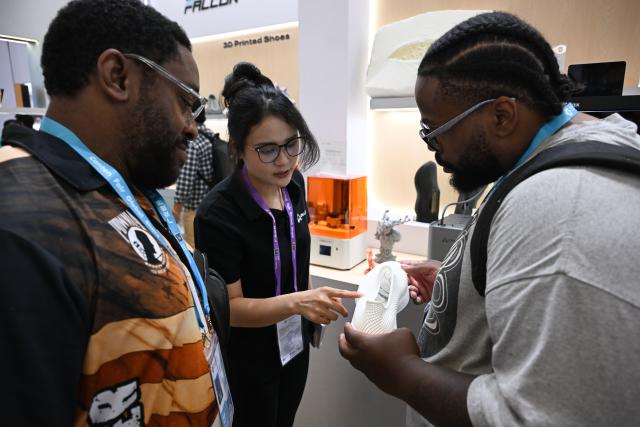 (261016) -- GUANGZHOU, Oct. 16, 2026 (Xinhua) -- A staff member (C) introduces a 3D-printed shoe to overseas buyers during the Canton Fair in Guangzhou, south China's Guangdong Province, Oct. 15, 2026. The 140th edition of the China Import and Export Fair, also known as the Canton Fair, opened to visitors in Guangzhou, capital of south China's Guangdong Province on Thursday, with more than 30,000 exhibiting companies and about 340,000 overseas buyers expected to attend.
  Serving as a barometer and wind vane of China's foreign trade, this year's fair, marking its 70th anniversary, features innovation, intelligence, greater specialization and higher quality.
  The Canton Fair is one of the world's few one-stop trade platforms offering a complete range of products with convenience and efficiency, while bringing together the latest products and technologies. (Xinhua/Deng Hua)