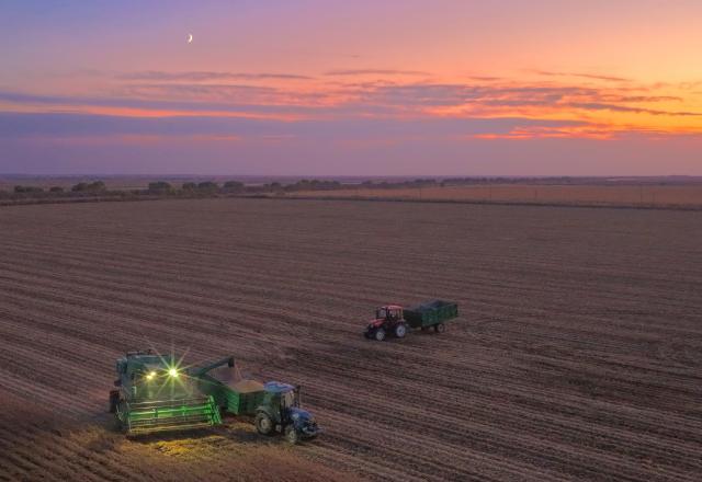 (261016) -- HARBIN, Oct. 16, 2026 (Xinhua) -- A drone photo taken on Oct. 15, 2026 shows farmers operating agricultural machines to harvest beans at a field in Hongsheng Town of Fujin City, northeast China's Heilongjiang Province. The autumn harvest in Heilongjiang, a northeastern province known as China's "grain barn," has been in full swing. (Photo by Geng Xiqing/Xinhua)