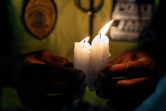 (261016) -- JOHANNESBURG, Oct. 16, 2026 (Xinhua) -- A police officer attends a candlelight vigil calling for an end to gender-based violence and femicide (GBVF) in Johannesburg, South Africa, Oct. 15, 2026. The vigil follows widespread national outrage after the discovery of 11 women's bodies across the city of Ekurhuleni, east of Johannesburg, since July. (Photo by Shiraaz Mohamed/Xinhua)