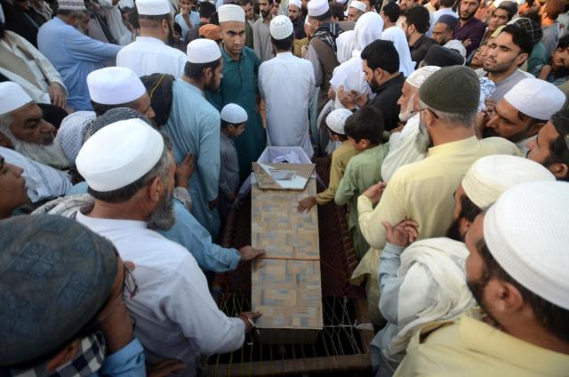 (261016) -- PESHAWAR, Oct. 16, 2026 (Xinhua) -- People attend the funeral of students killed in a school roof collapse incident in northwest Pakistan's Peshawar on Oct. 15, 2026. The death toll from a school roof collapse in Pakistan's northwest Khyber Pakhtunkhwa province on Thursday has reached 33, with 17 injured people discharged after observation, hospital officials and a rescue service spokesperson confirmed to Xinhua. (Str/Xinhua)