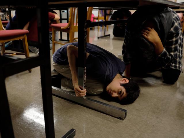 (261016) -- LOS ANGELES, Oct. 16, 2026 (Xinhua) -- Students take cover in their classroom during the "Great California ShakeOut," an annual statewide earthquake preparedness drill, at John C. Fremont High School in Los Angeles, California, the United States, Oct. 15, 2026. (Photo by Qiu Chen/Xinhua)