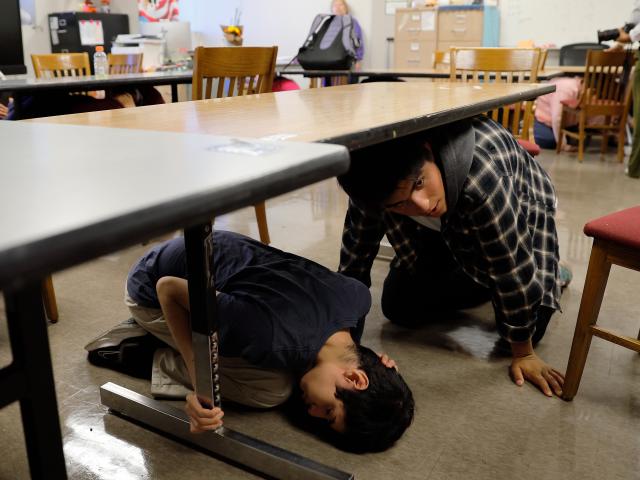 (261016) -- LOS ANGELES, Oct. 16, 2026 (Xinhua) -- Students take cover in their classroom during the "Great California ShakeOut," an annual statewide earthquake preparedness drill, at John C. Fremont High School in Los Angeles, California, the United States, Oct. 15, 2026. (Photo by Qiu Chen/Xinhua)