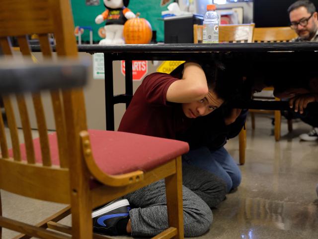 (261016) -- LOS ANGELES, Oct. 16, 2026 (Xinhua) -- Students take cover in their classroom during the "Great California ShakeOut," an annual statewide earthquake preparedness drill, at John C. Fremont High School in Los Angeles, California, the United States, Oct. 15, 2026. (Photo by Qiu Chen/Xinhua)