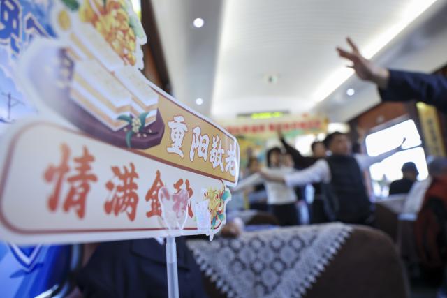 (261016) -- HARBIN, Oct. 16, 2026 (Xinhua) -- Crew members lead passengers to do traditional Chinese fitness exercises aboard the train Z114, on Oct. 16, 2026.
  The train Z114 service from Harbin West Railway Station to Haikou in south China's Hainan Province has witnessed a surging passenger loads since early October when temperatures started to drop in Heilongjiang Province.
   Covering about 4,300 kilometers in 47 hours and 50 minutes, the train is a popular choice among elderly travelers from northeast China heading south to escape the bitter winter cold.
   The China Railway Harbin Group provides elderly-friendly services and additional assistance for passengers with special needs to make their journeys more comfortable. (Xinhua/Wang Song)