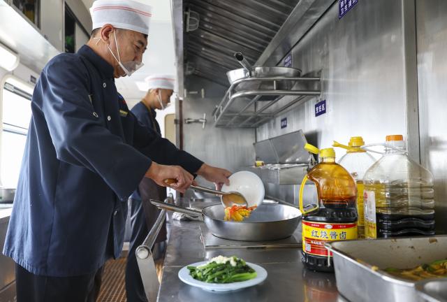 (261016) -- HARBIN, Oct. 16, 2026 (Xinhua) -- Crew members prepare meals for passengers aboard the train Z114, on Oct. 16, 2026.
  The train Z114 service from Harbin West Railway Station to Haikou in south China's Hainan Province has witnessed a surging passenger loads since early October when temperatures started to drop in Heilongjiang Province.
   Covering about 4,300 kilometers in 47 hours and 50 minutes, the train is a popular choice among elderly travelers from northeast China heading south to escape the bitter winter cold.
   The China Railway Harbin Group provides elderly-friendly services and additional assistance for passengers with special needs to make their journeys more comfortable. (Xinhua/Wang Song)
