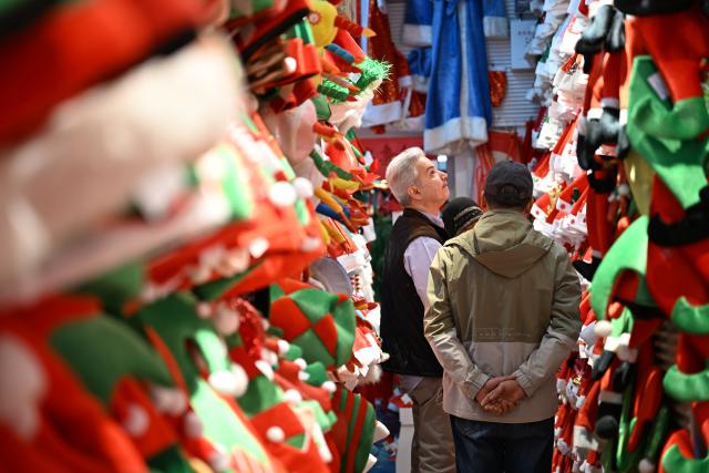 (261016) -- BEIJING, Oct. 16, 2026 (Xinhua) -- A merchant selects Christmas products at the Yiwu International Trade Market in Yiwu, east China's Zhejiang Province, Dec. 17, 2025. (Xinhua/Liu Mingxiang)