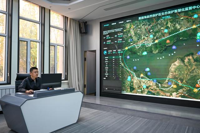 (261016) -- ULANQAB, Oct. 16, 2026 (Xinhua) -- A staff member watches real-time data on the Huangqihai Lake nature reserve at a smart monitoring center of the reserve in Ulanqab, north China's Inner Mongolia Autonomous Region, Oct. 16, 2026.
  Huangqihai Lake in Ulanqab was once on the verge of drying up due to climate and other impacts. After years of comprehensive conservation, its water body has gradually been restored and expanded. (Xinhua/Bei He)