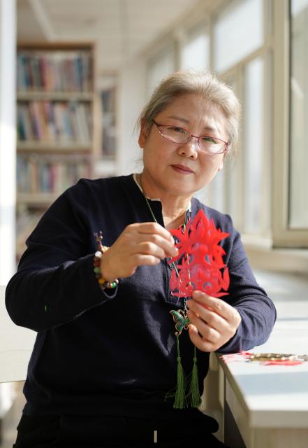 (261016) -- CHAOYANG, Oct. 16, 2026 (Xinhua) -- Yang Zhihong shows her papercut work at an art exhibition hall in Jianping County of Chaoyang City, northeast China's Liaoning Province, Oct. 10, 2026. Known for its bold, rustic style and designs inspired by folk stories and traditional symbols, Jianping paper-cutting reflects the rich culture of western Liaoning Province.
   Born in 1972, Yang Zhihong is a representative inheritor of Jianping paper-cutting, a provincial-level intangible cultural heritage of Liaoning Province. Inspired by local folk artists from an early age, she has devoted herself to preserving this traditional art. 
   Over decades of practice, Yang has won several major industry awards. Today, she continues to explore the art's cultural heritage and create new works, keeping this ancient folk tradition alive. (Xinhua/Li Gang)