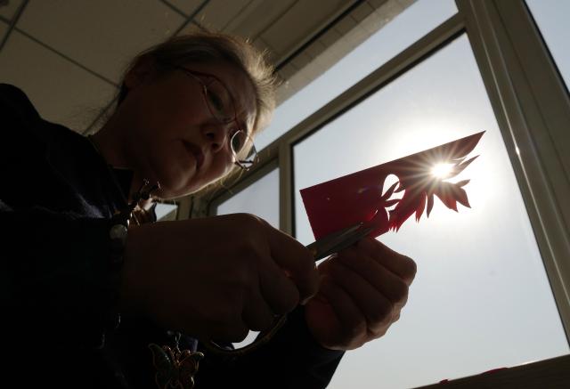 (261016) -- CHAOYANG, Oct. 16, 2026 (Xinhua) -- Yang Zhihong makes a papercut work at an art exhibition hall in Jianping County of Chaoyang City, northeast China's Liaoning Province, Oct. 10, 2026. Known for its bold, rustic style and designs inspired by folk stories and traditional symbols, Jianping paper-cutting reflects the rich culture of western Liaoning Province.
   Born in 1972, Yang Zhihong is a representative inheritor of Jianping paper-cutting, a provincial-level intangible cultural heritage of Liaoning Province. Inspired by local folk artists from an early age, she has devoted herself to preserving this traditional art. 
   Over decades of practice, Yang has won several major industry awards. Today, she continues to explore the art's cultural heritage and create new works, keeping this ancient folk tradition alive. (Xinhua/Li Gang)