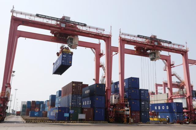 (261016) -- BEIHAI, Oct. 16, 2026 (Xinhua) -- This photo taken on Oct. 15, 2026 shows a terminal of Tieshan Port in Beihai, south China's Guangxi Zhuang Autonomous Region. Taking advantage of its ports, resources as well as geographical location, Beihai has in recent years focused on developing eight pillar industries such as green chemicals, metal materials, information technology, and marine engineering equipment. It is accelerating the building of a modern and ocean-oriented industrial system featuring intelligence, greenness and integration. (Xinhua/Lu Peng)