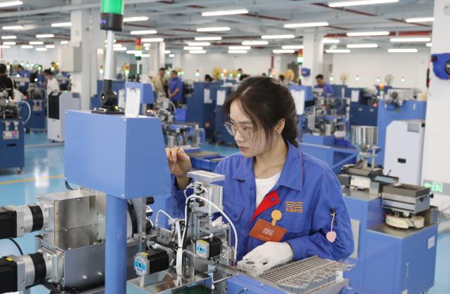 (261016) -- BEIHAI, Oct. 16, 2026 (Xinhua) -- A staff member works at a workshop of Yongxing Tech in Beihai, south China's Guangxi Zhuang Autonomous Region, Oct. 16, 2026. Taking advantage of its ports, resources as well as geographical location, Beihai has in recent years focused on developing eight pillar industries such as green chemicals, metal materials, information technology, and marine engineering equipment. It is accelerating the building of a modern and ocean-oriented industrial system featuring intelligence, greenness and integration. (Xinhua/Lu Peng)
