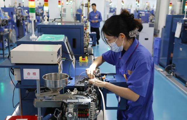 (261016) -- BEIHAI, Oct. 16, 2026 (Xinhua) -- A staff member works at a workshop of Yongxing Tech in Beihai, south China's Guangxi Zhuang Autonomous Region, Oct. 16, 2026. Taking advantage of its ports, resources as well as geographical location, Beihai has in recent years focused on developing eight pillar industries such as green chemicals, metal materials, information technology, and marine engineering equipment. It is accelerating the building of a modern and ocean-oriented industrial system featuring intelligence, greenness and integration. (Xinhua/Lu Peng)