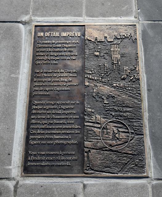 (261016) -- PARIS, Oct. 16, 2026 (Xinhua) -- This photo taken on Oct. 16, 2026 shows a plaque titled "An Unexpected Detail" in Paris, France. A bronze plaque titled "An Unexpected Detail" was unveiled at Place de la Republique in Paris on Thursday. It honors "Boulevard du Temple," an image taken in 1838 by French photography pioneer Louis Daguerre and believed to be the first photograph to show people. (Xinhua/Wu Huiwo)