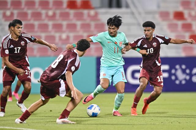 (261017) -- DOHA, Oct. 17, 2026 (Xinhua) -- Omar Ayman Mahmoud (1st R) of Qatar vies with Liu Yuyang (2nd R) of China during the Gulf Football Federation (GFF) Gulf Cup U-17 Qatar 2026 football match between Qatar and China at Grand Hamad Stadium in Doha, Qatar, Oct. 16, 2026. (Photo by Nikku/Xinhua)
