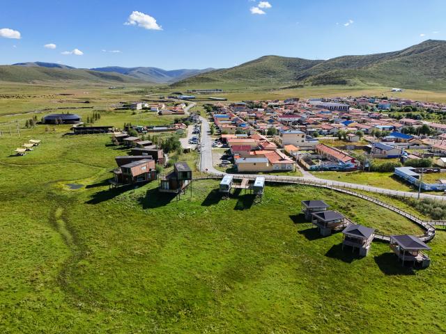 (261017) -- CHENGDU, Oct. 17, 2026 (Xinhua) -- An aerial drone photo taken on Aug. 13, 2026 shows homestays in Xiahalama Village of Hongyuan County of Aba Tibetan and Qiang Autonomous Prefecture, southwest China's Sichuan Province. TO GO WITH "Across China: A young returnee's bet on the 'sea of death'" (Xinhua/Wang Xi)